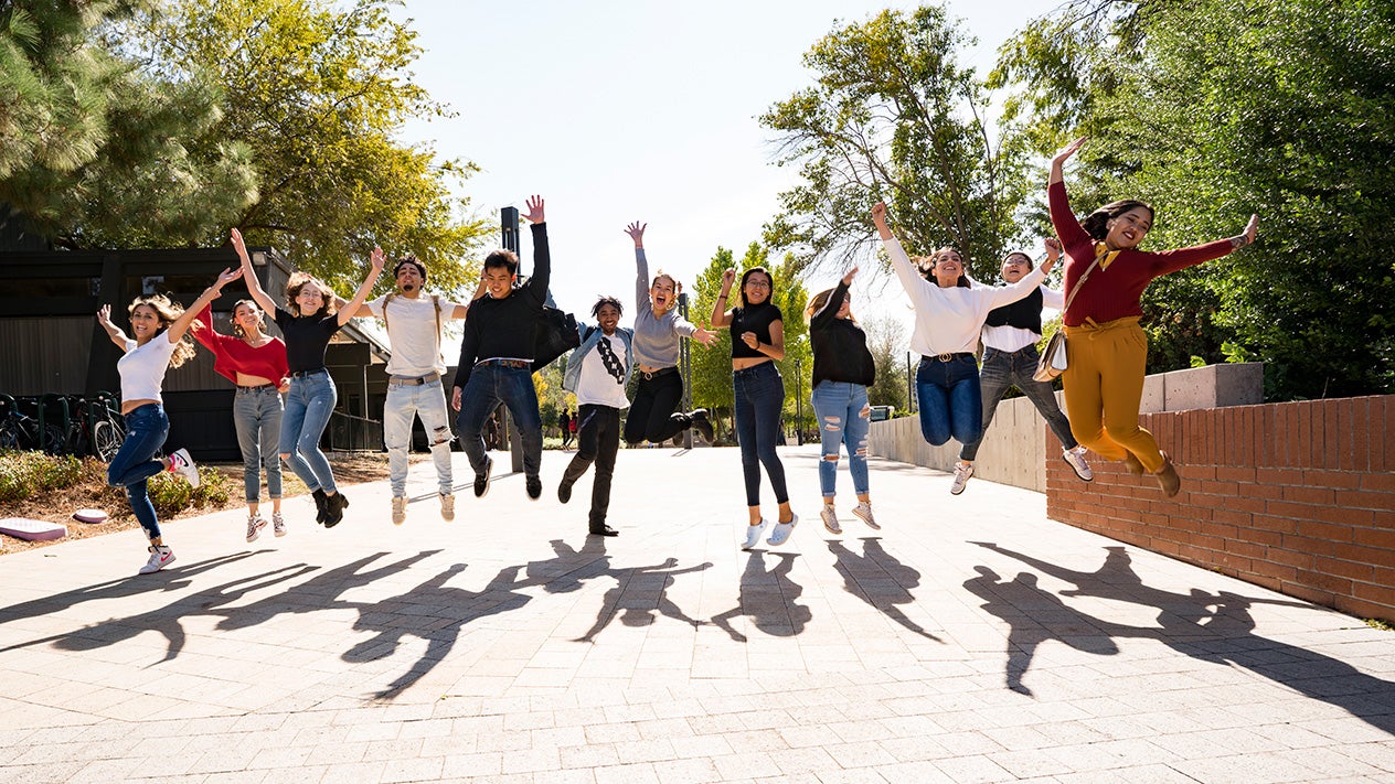 Happy DVC students jump in the air in celebration of a successful first year experience.