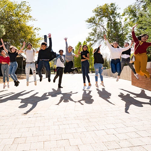 Happy DVC students jump in the air in celebration of a successful first year experience.