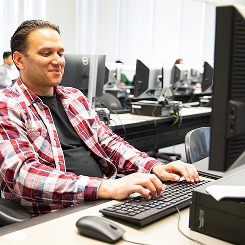 Student typing on a computer