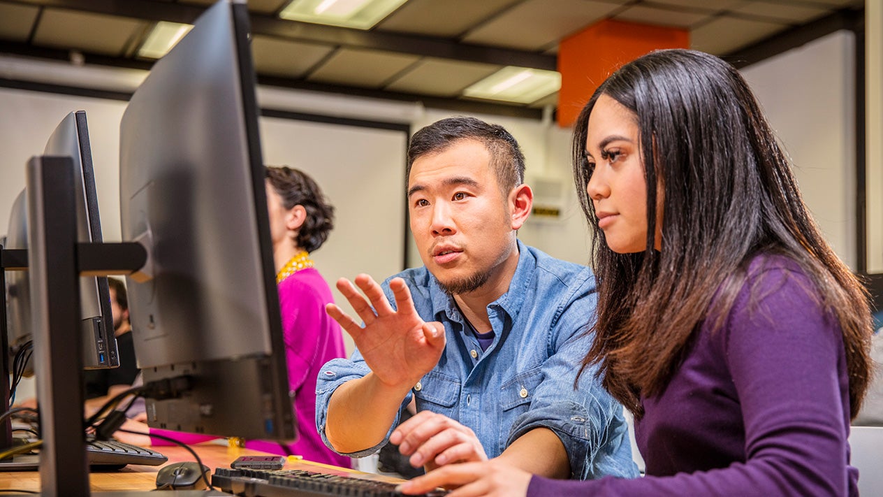 Student and teacher with computer