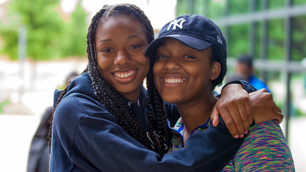 Two students smiling