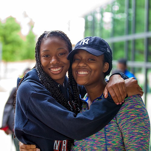 Two students smiling