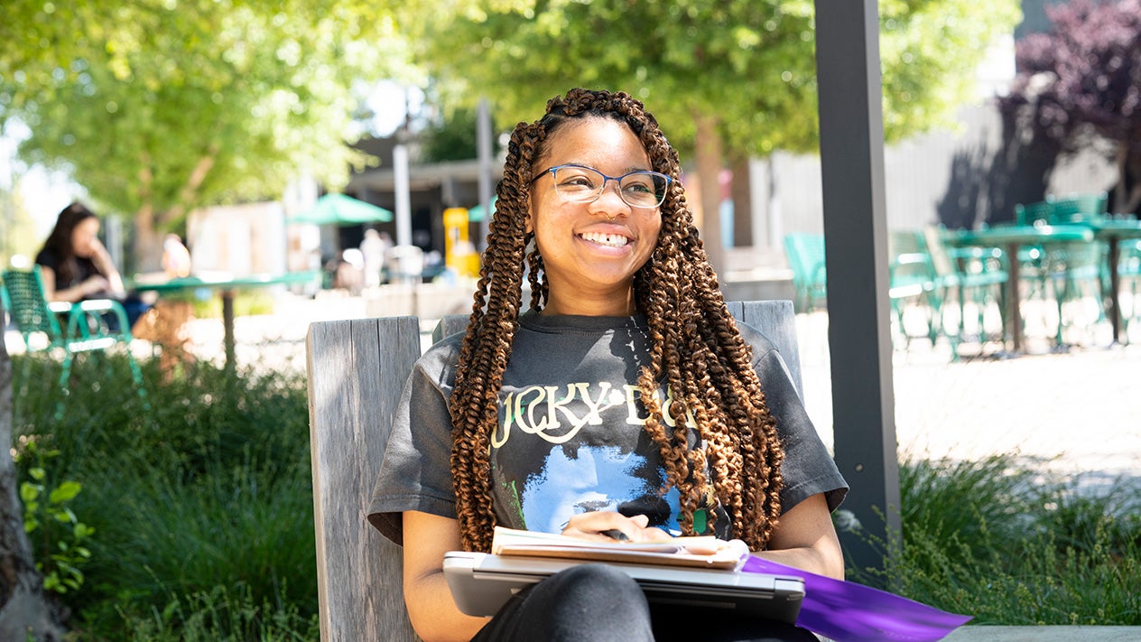 Student with book outside