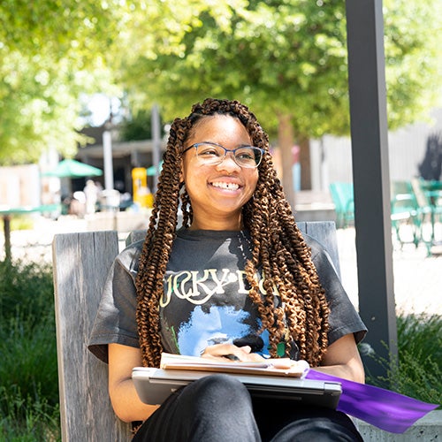 Student with book outside