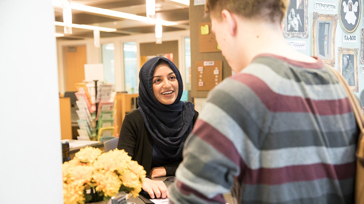 A DVC student works with a student worker at the Welcome Center.