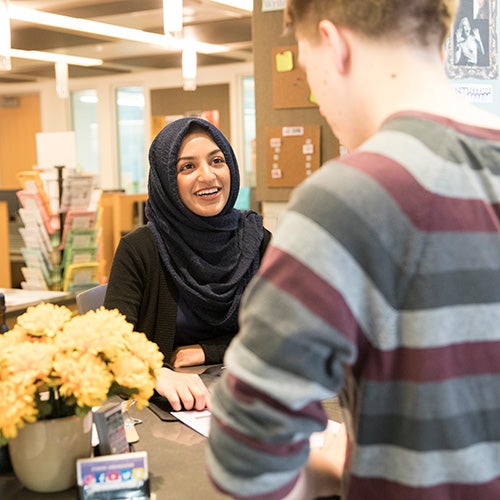 A DVC student works with a student worker at the Welcome Center.