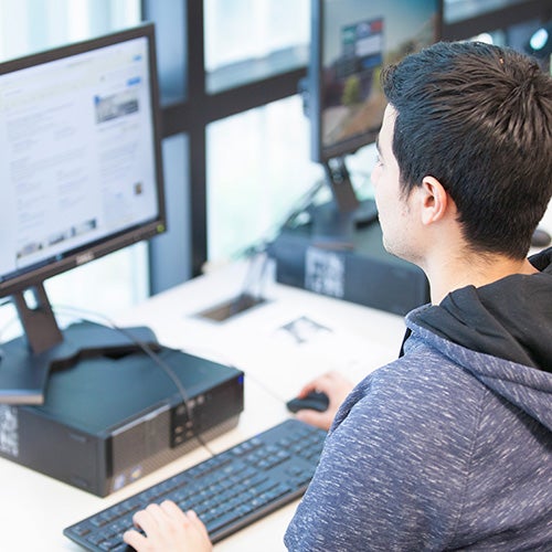 A DVC students works on a computer.