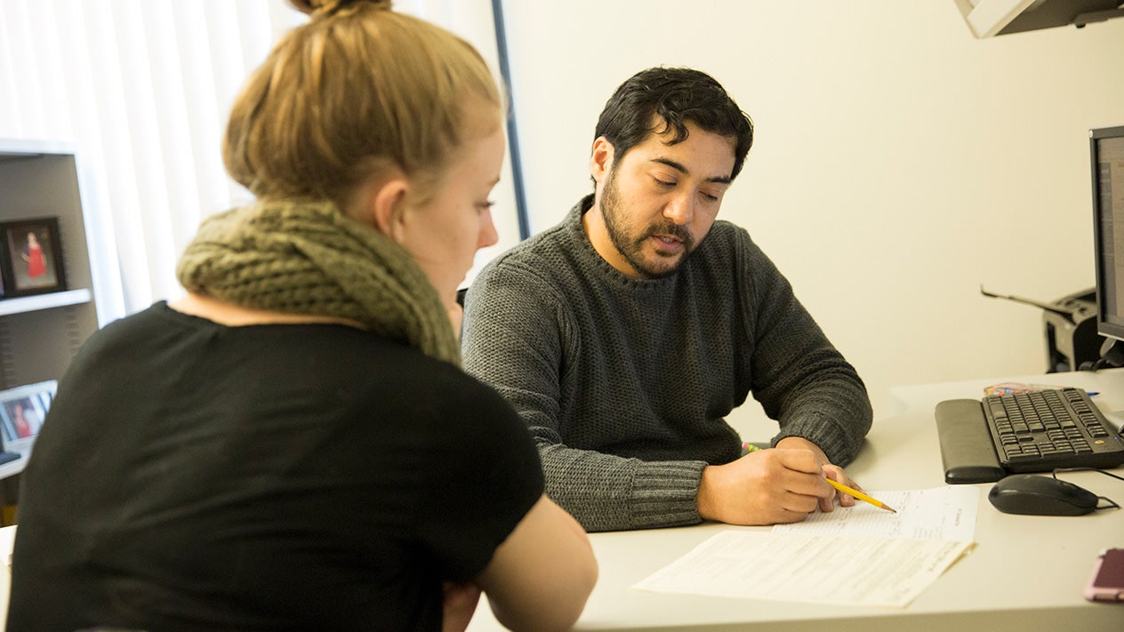 A DVC counselor works with a student.