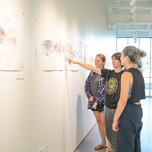 DVC students discussing an exhibit in the Art Gallery.