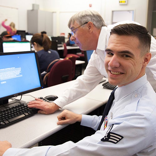 A DVC counselor works with a veteran student.