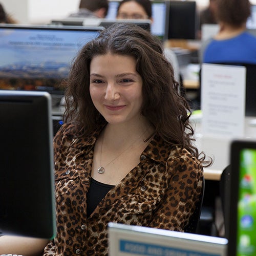 Business student with computer in classroom 