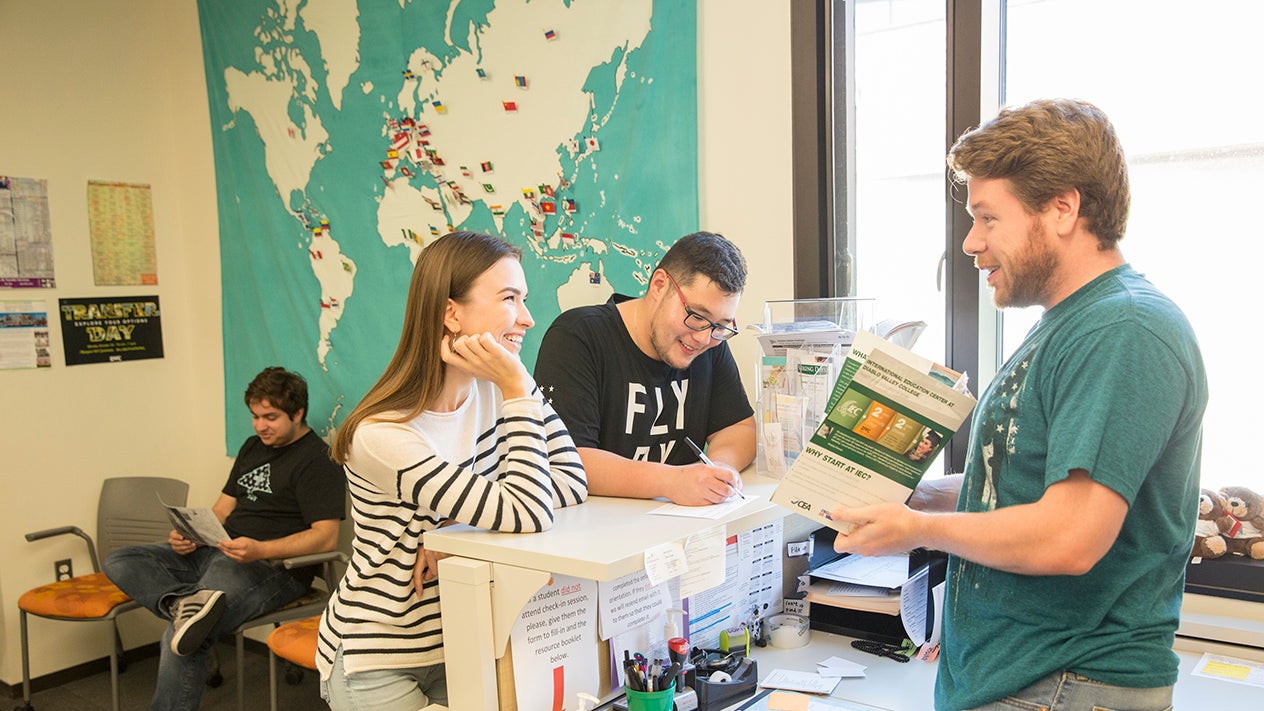 DVC students chatting near a map showing different locations indicated