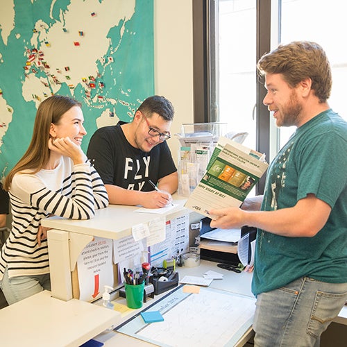 DVC students chatting near a map showing different locations indicated