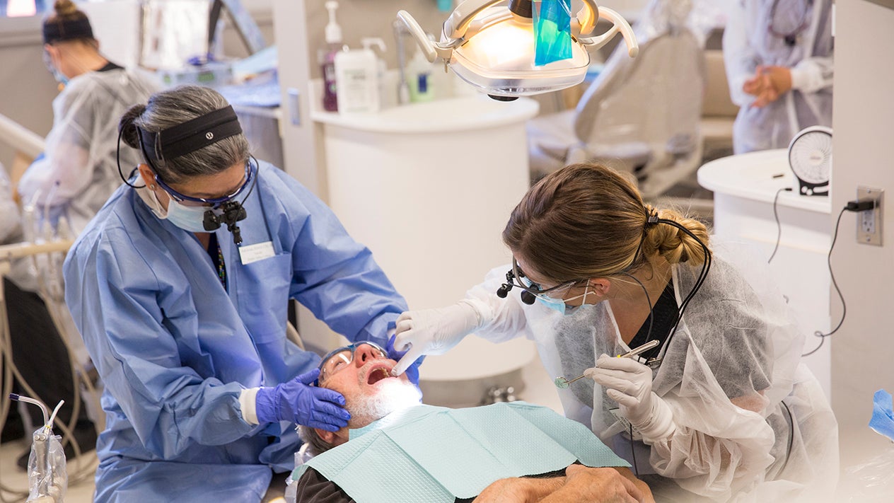 Dental Hygiene teacher and student with patient