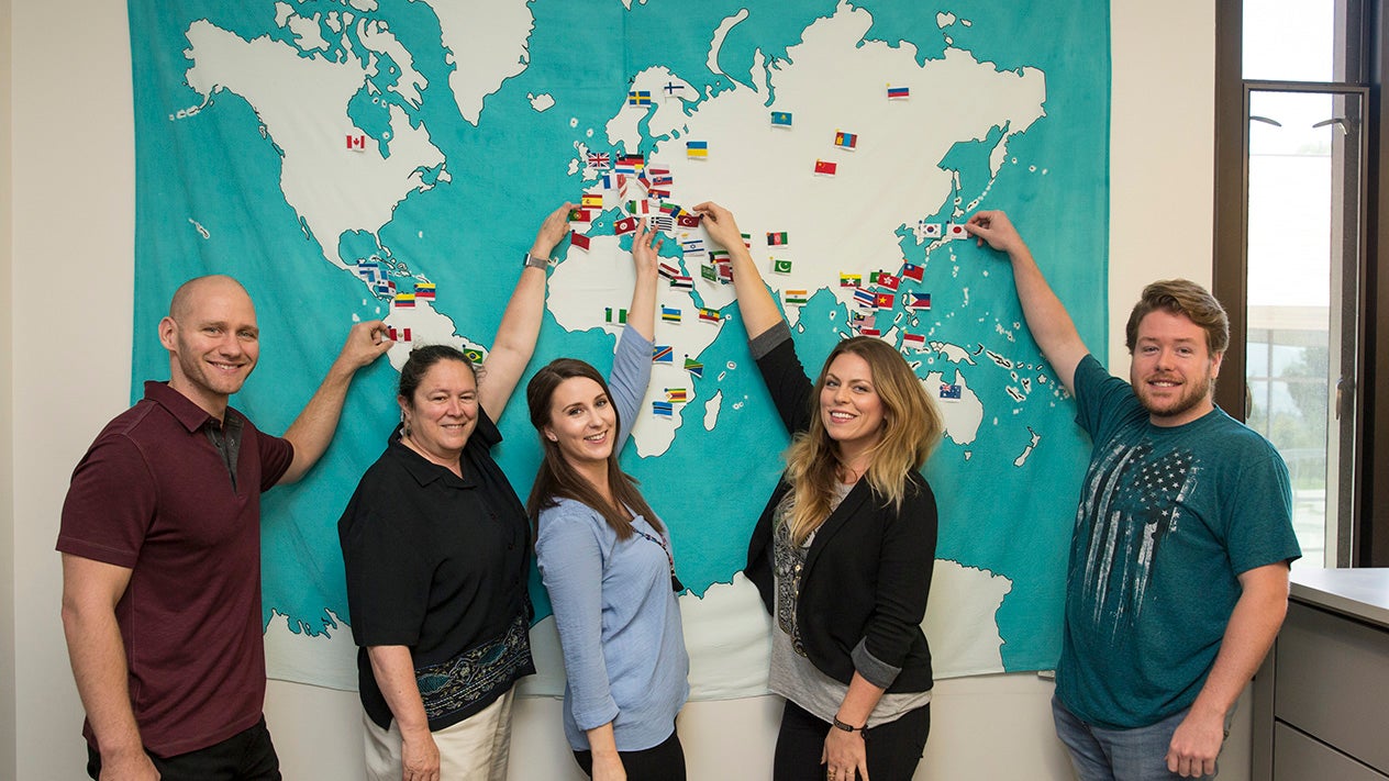 DVC students showing places on a map on the wall