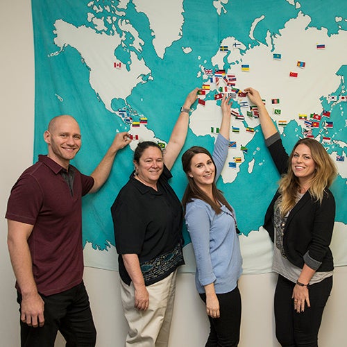 DVC students showing places on a map on the wall