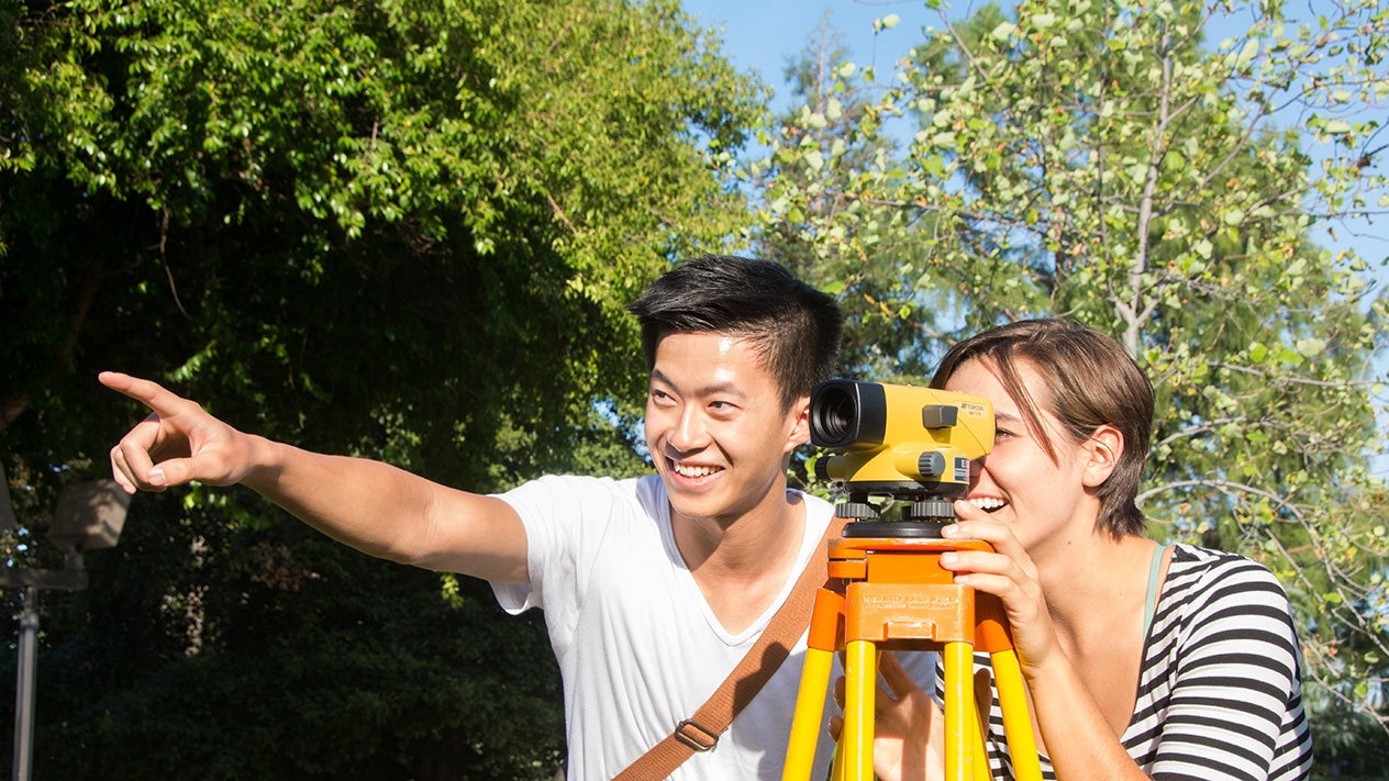 Students using surveying equipment