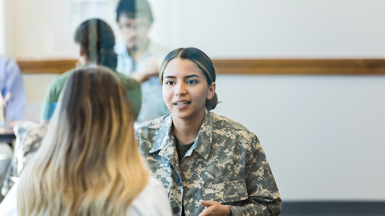 DVC student veteran talking with another student