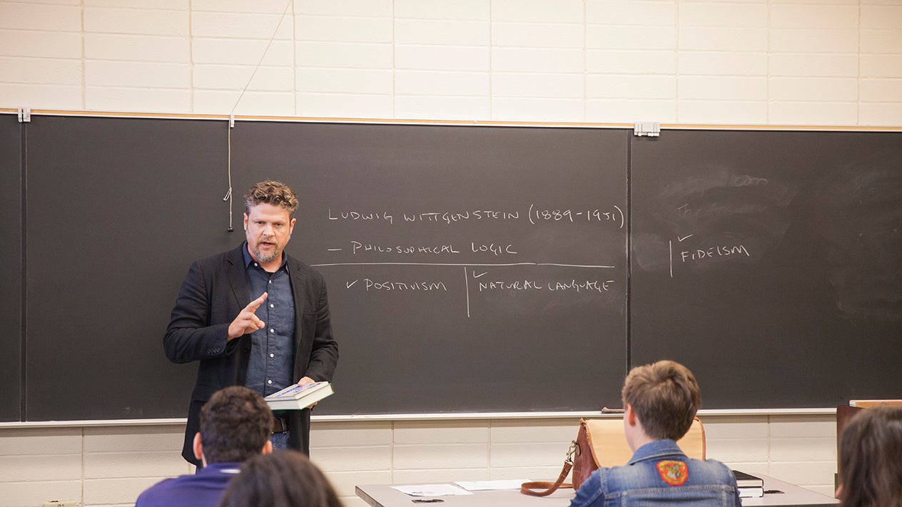 Philosophy teacher in a classroom with students