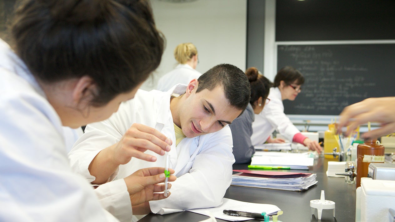 Oceanography students with test tubes in a classroom