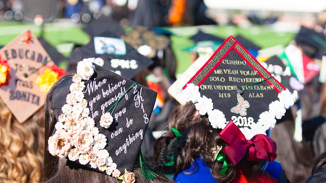 DVC students showing their decorated graduation caps