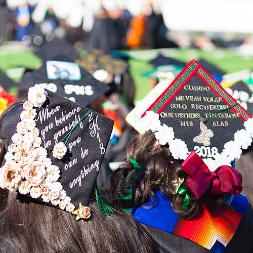 DVC students showing their decorated graduation caps