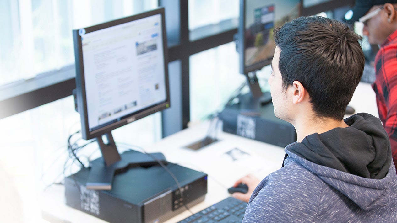 DVC student typing on keyboard while looking at monitor