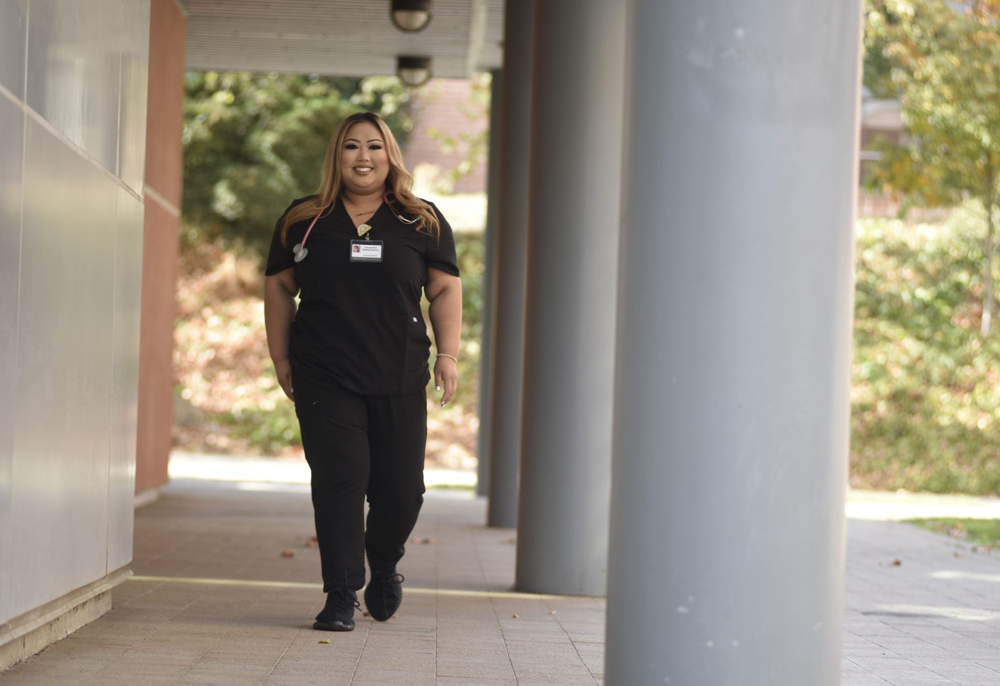 Allied health alumni Alexandra Sooksumphon walking on DVC campus