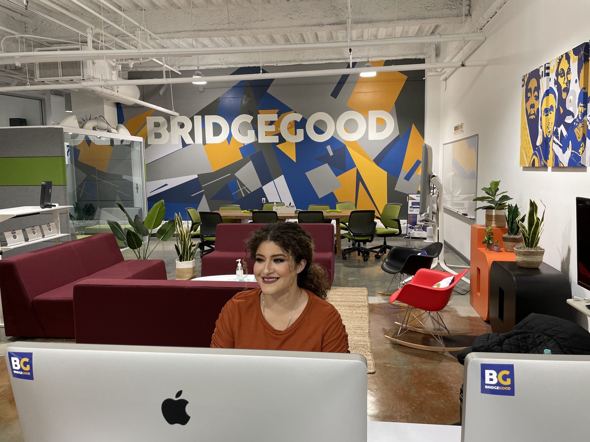 DVC alum Herrara Orellana, sitting at her desk at BRIDGEGOOD