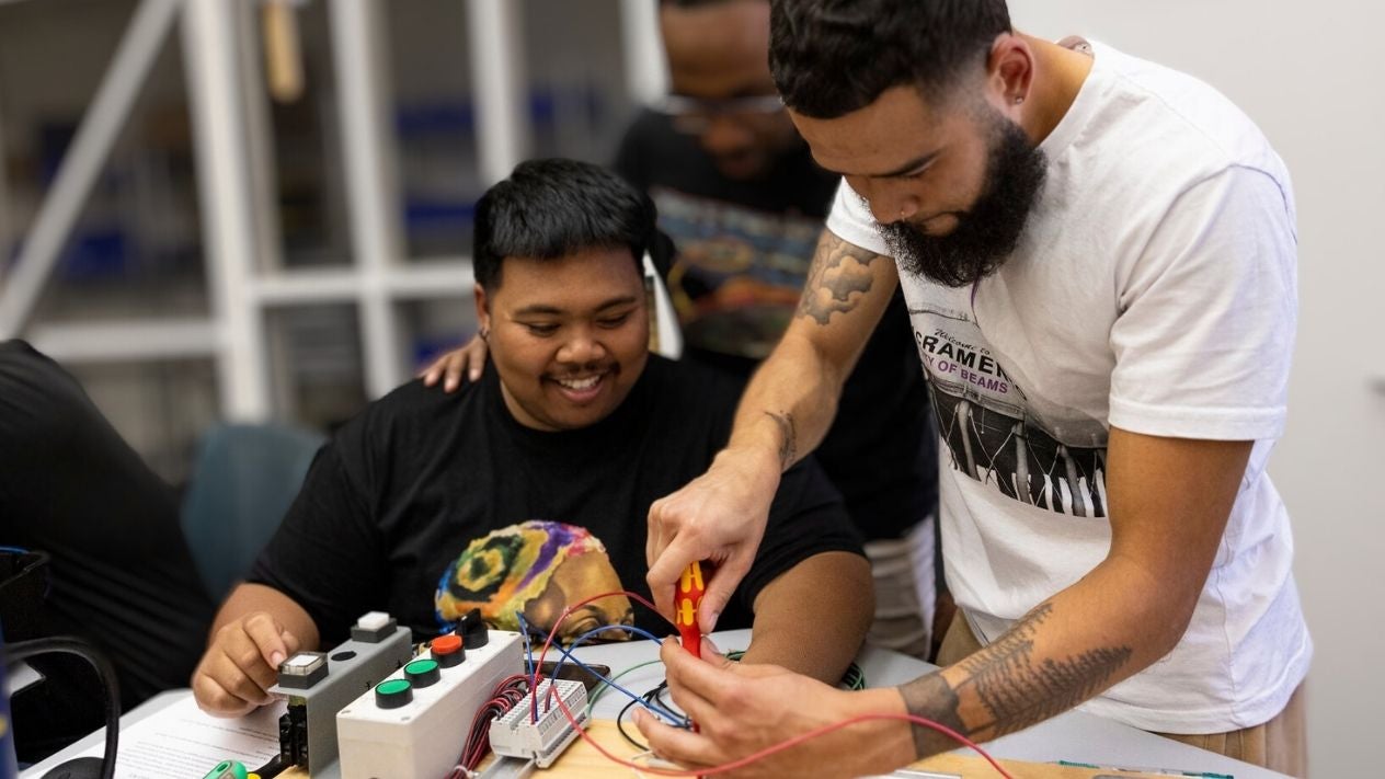 Male students working on electronics