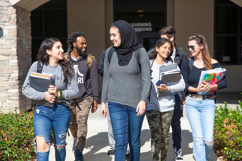 A group of students happily walking and chatting