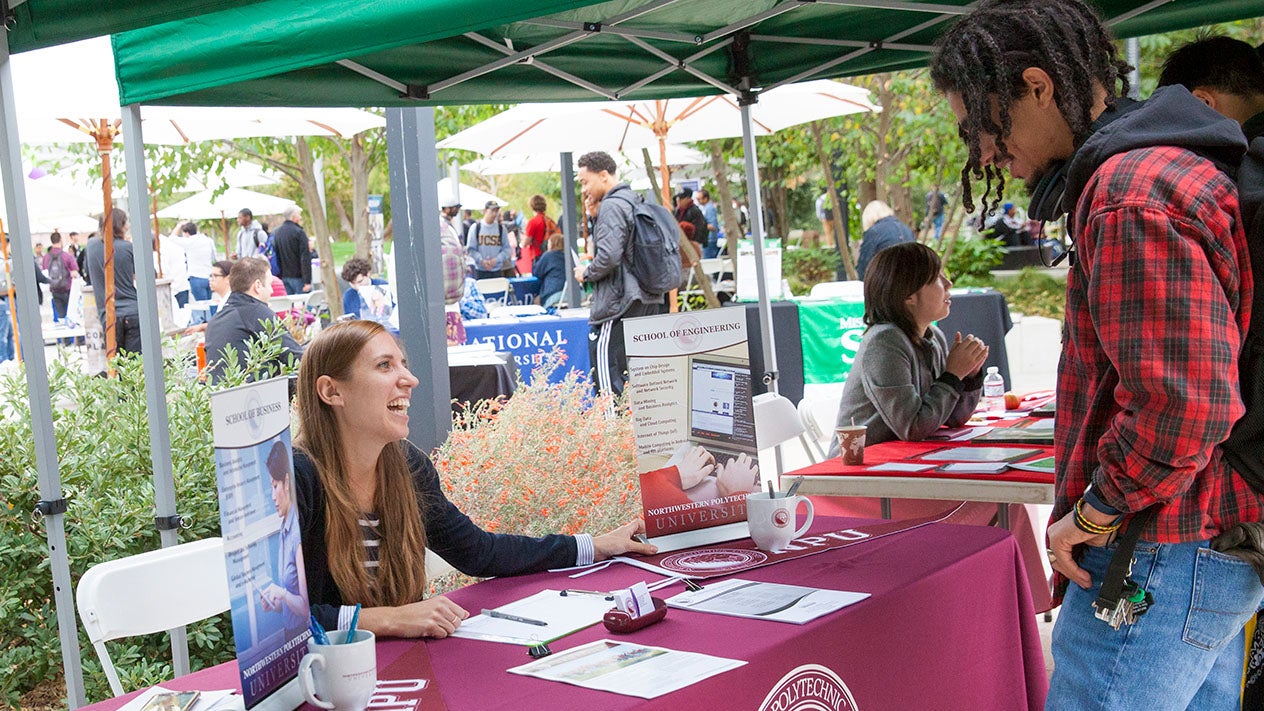 A DVC students talks with a representative from a transfer school.