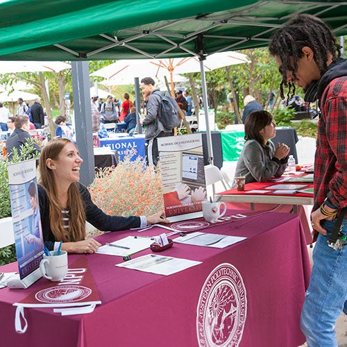 A DVC students talks with a representative from a transfer school.