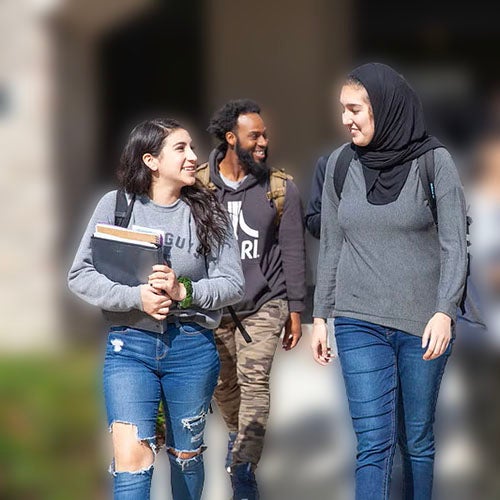 Students walking by building