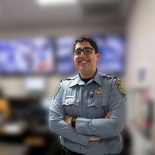 Police officer smiling and cross-armed pose